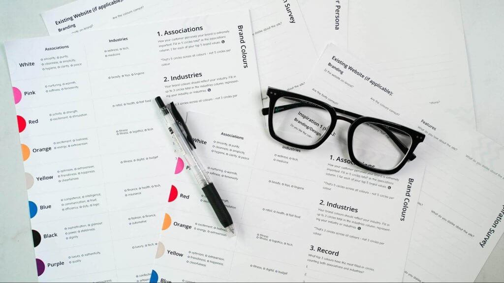 a pen and glasses on papers